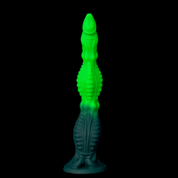 Glow Tyrant dildo – full side view, luminescent green ridged shaft on a dark base