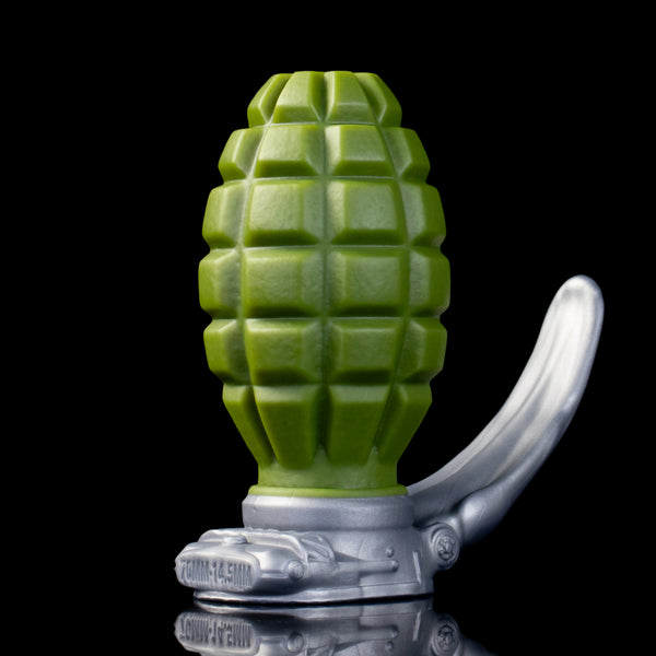 Swallow Bomb anal plug – upright view of the green grenade body, safety bar and tank relief base