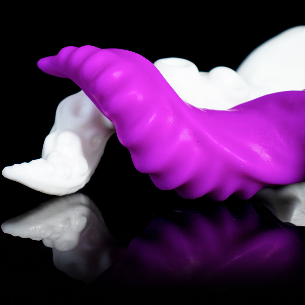 Symbiotic Spiral fantasy dildo – ribbed shaft lying in front of the nodule shaft, spiral ribs in focus